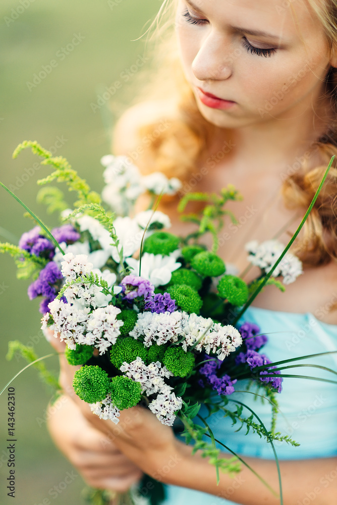 Portrait of a curly girl with flowers