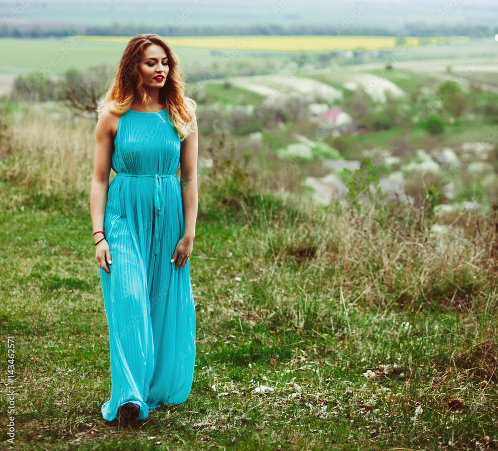 The charming girl stands on the mountain The charming girl stands on the mountain