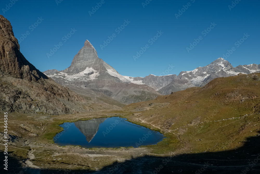 View on Matterhorn reflected in Lake Riffelsee, near Zermatt, Switzerland. View on Matterhorn reflected in Lake Riffelsee, near Zermatt, Switzerland.