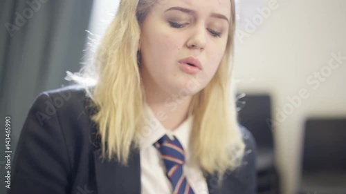  Teen girl singing solo & playing keyboard instrument in school music lesson