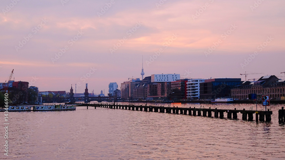 View on Oberbaum Bridge and TV Tower on the sunset in Berlin, Germany.