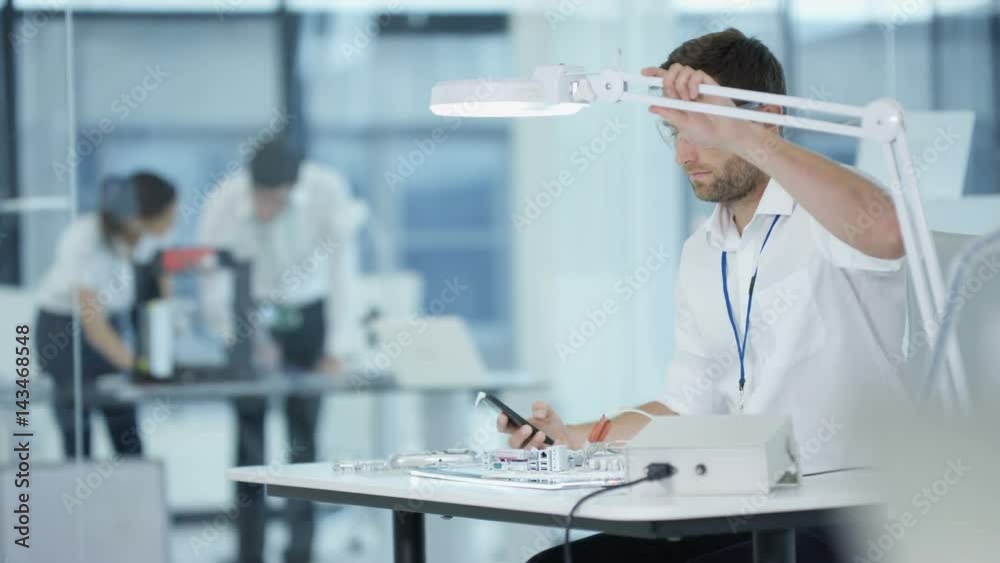  Electronics engineer working in lab building & testing electronic devices