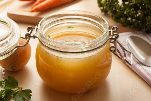 Фотография Bone broth made from chicken in a glass jar