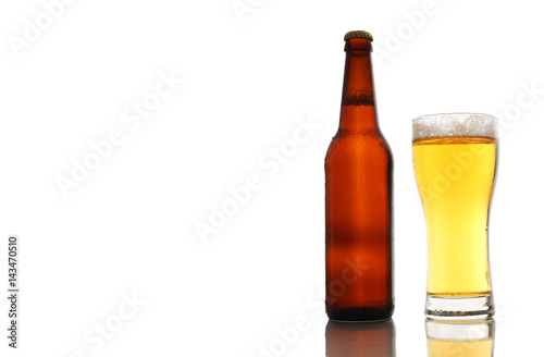 Bottle and a glass of beer with foam isolated on white background