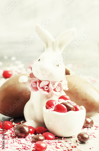 Easter composition with a rabbit and eggs, gray background, selective focus