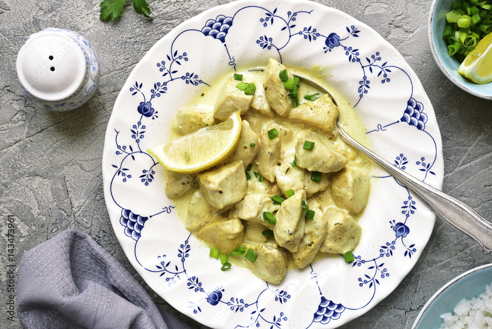 Chicken fricassee in a white sauce garnished with boiled rice.Top view. Chicken fricassee in a white sauce garnished with boiled rice.Top view.