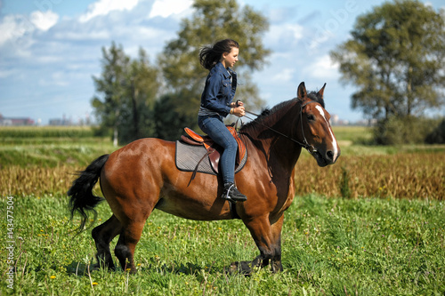 Little teenage girl riding a horse