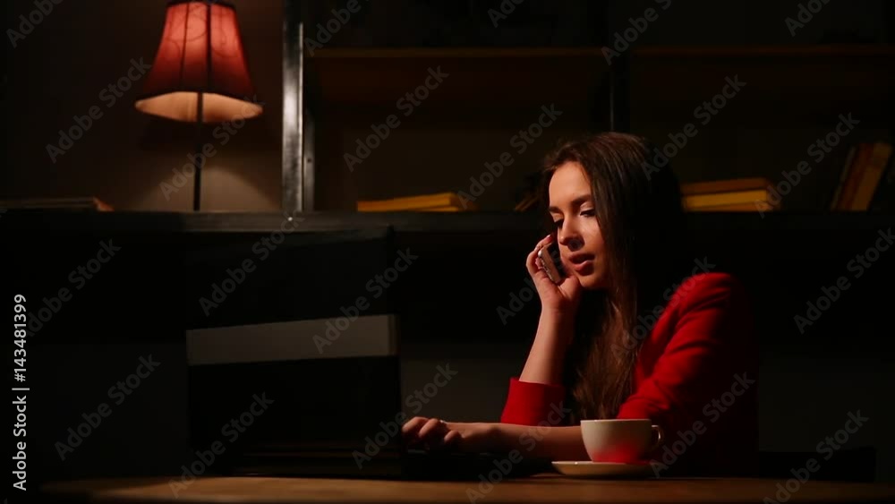 The girl in the red jacket Smoking the electronic cigarette and talking on a cell phone. The girl in the red jacket Smoking the electronic cigarette and talking on a cell phone.