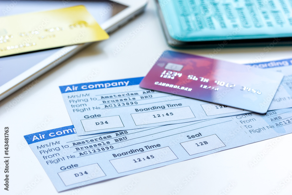 Credit cards with airline tickets for vacations on table background Credit cards with airline tickets for vacations on table background
