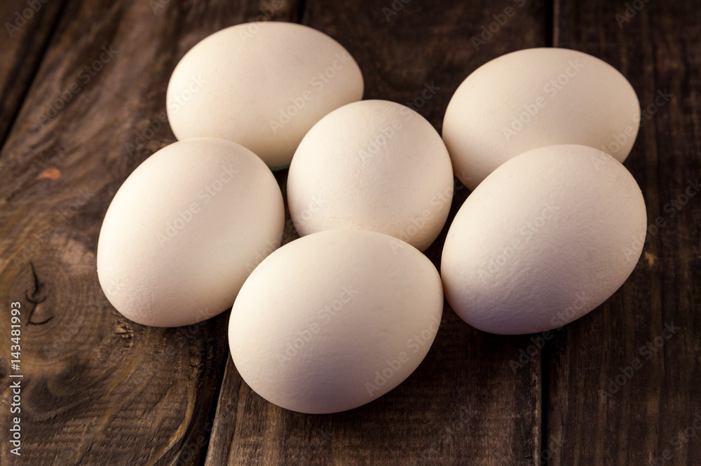 Raw fresh white farmer's chicken eggs on rustic wooden background. Healthy and sport food. Easter theme.
Raw fresh white farmer's chicken eggs on rustic wooden background. Healthy and sport food. Easter theme.