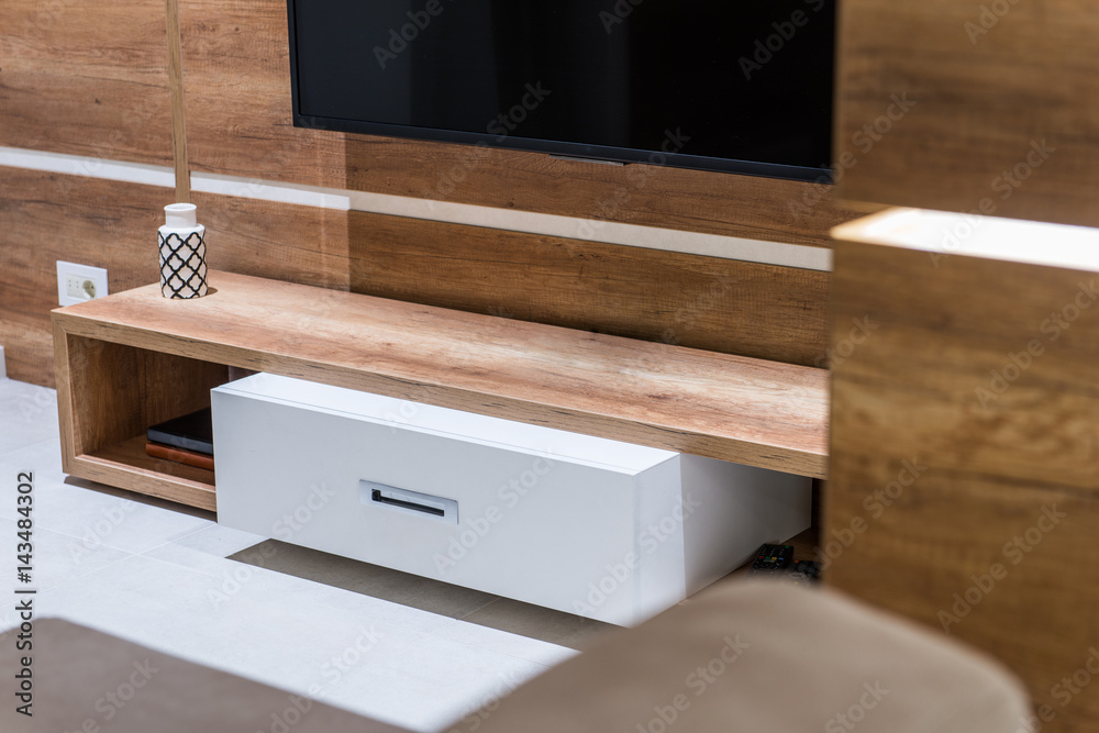 Modern wooden commode for tv set in living room interior Modern wooden commode for tv set in living room interior