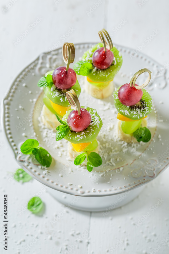 Tasty finger food with various fruits and mint for party Tasty finger food with various fruits and mint for party