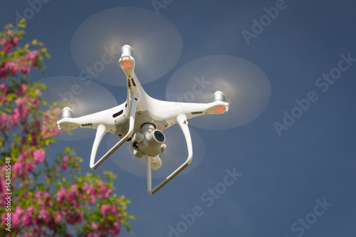 Unmanned Aircraft System (UAV) Quadcopter Drone In The Air.
