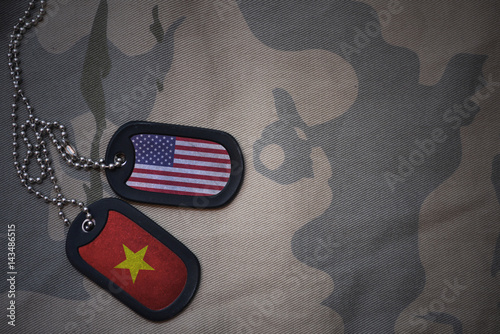 Bild auf Leinwand army blank, dog tag with flag of united states of america and vietnam on the khaki texture background
