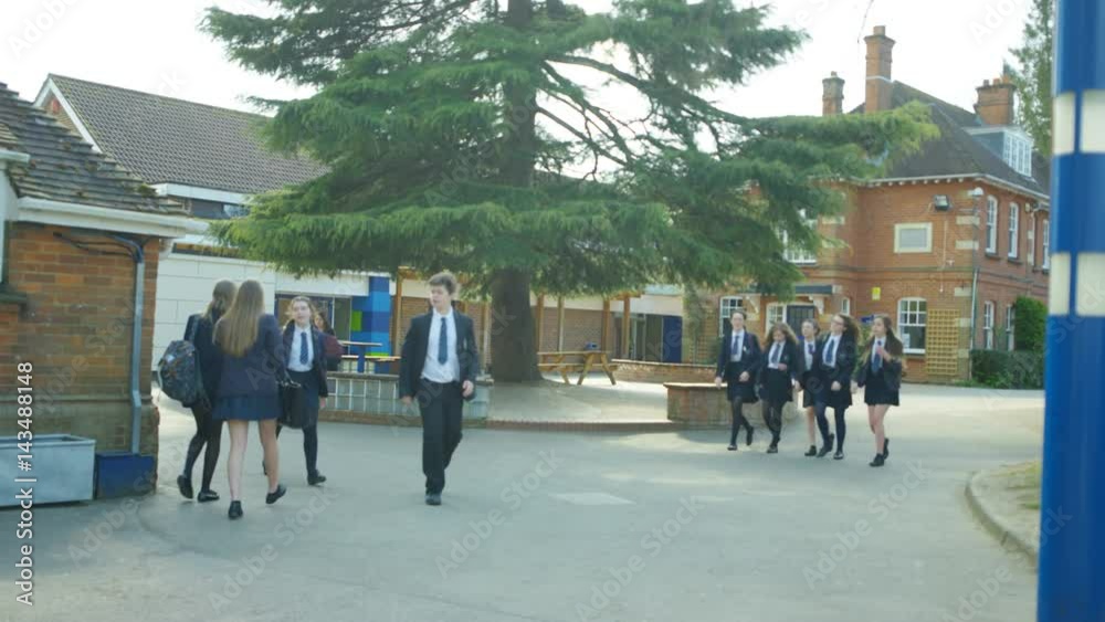 Young children walking into school building at the beginning of the day