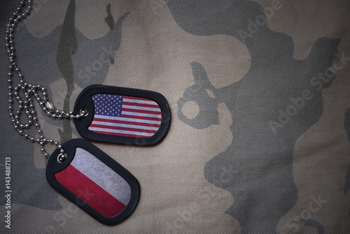 Bild auf Leinwand army blank, dog tag with flag of united states of america and poland on the khaki texture background