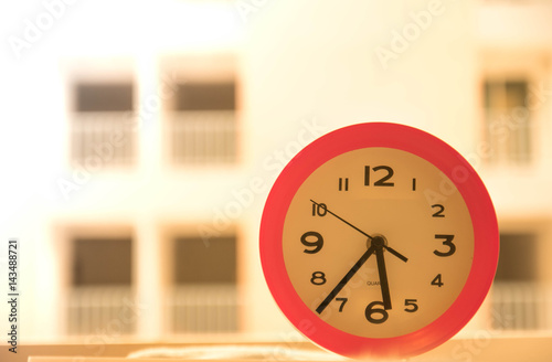 Pink clock on the table photo