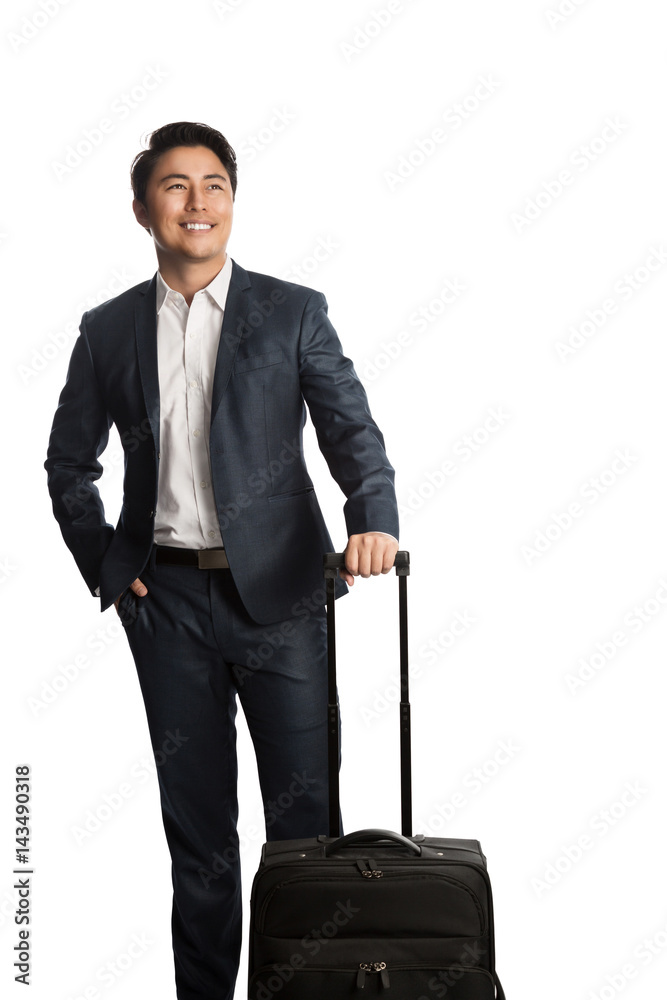 Attractive young businessman in a blue suit and white shirt, standing against a white background holding a bag getting ready for traveling. Attractive young businessman in a blue suit and white shirt, standing against a white background holding a bag getting ready for traveling.