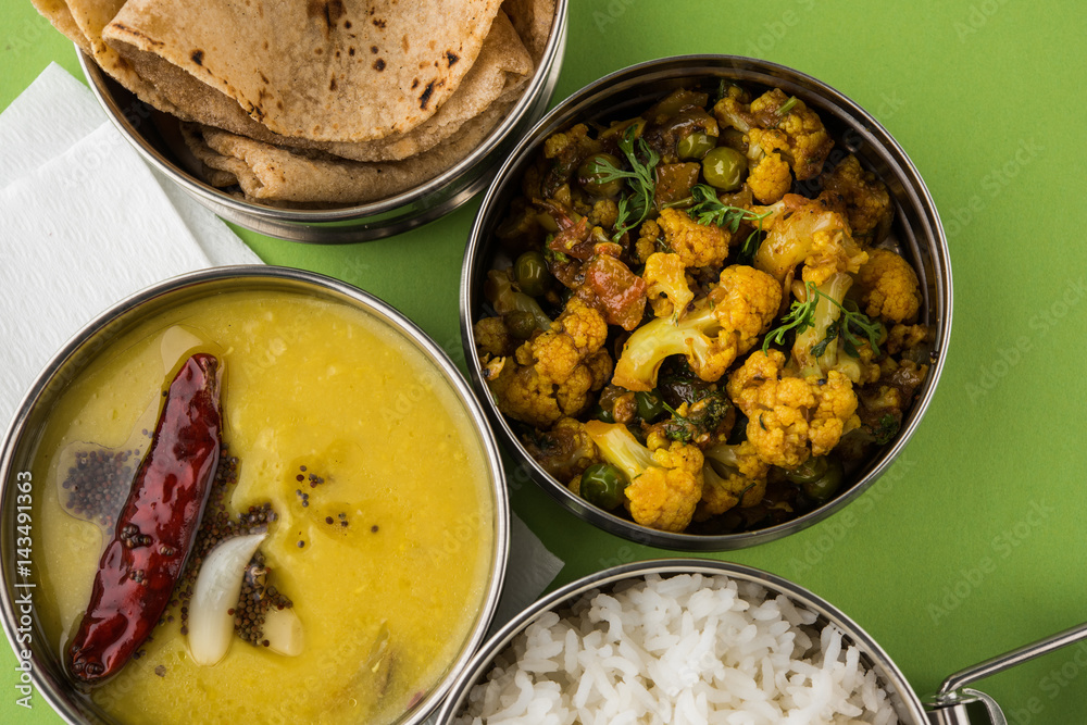 indian typical stainless steel lunch box or tiffin with north indian or