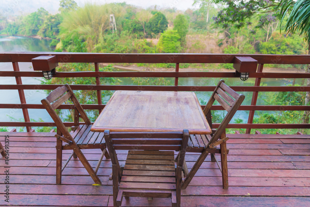 Wooden table and chair in resort and garden, dining set at wooden terrace in restaurant. Wooden table and chair in resort and garden, dining set at wooden terrace in restaurant.