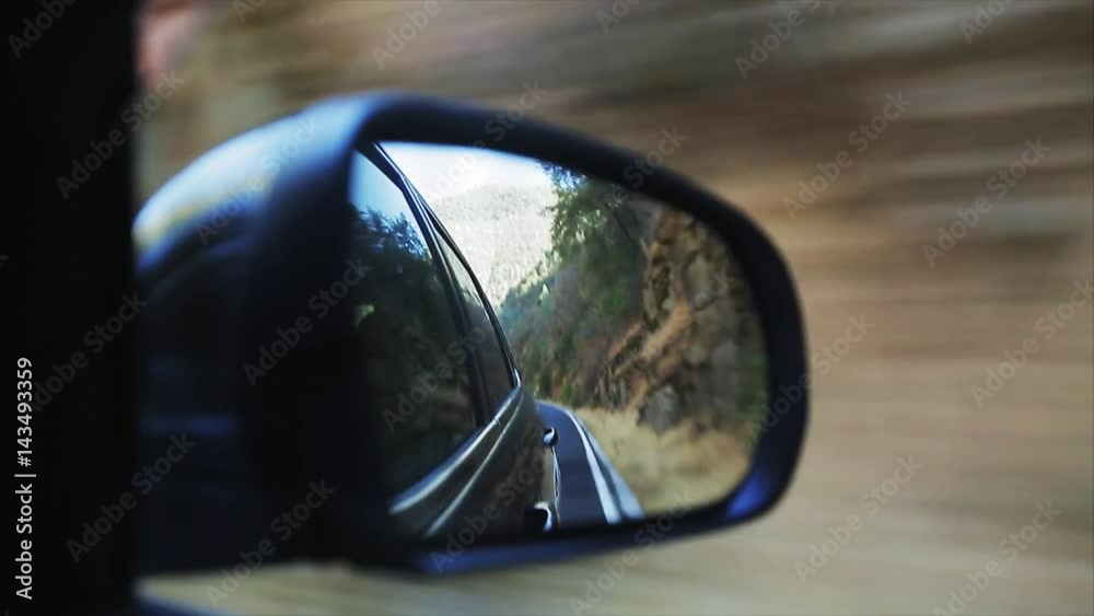 Reflection of the road in the mountains in the wing mirror Reflection of the road in the mountains in the wing mirror