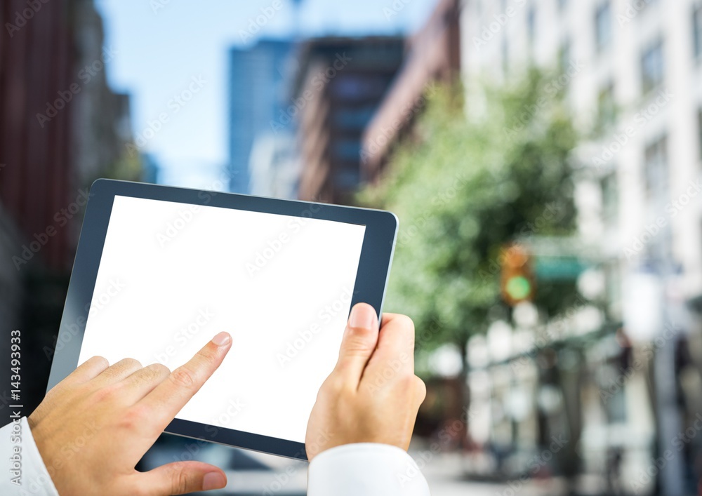 Hands with tablet in the city