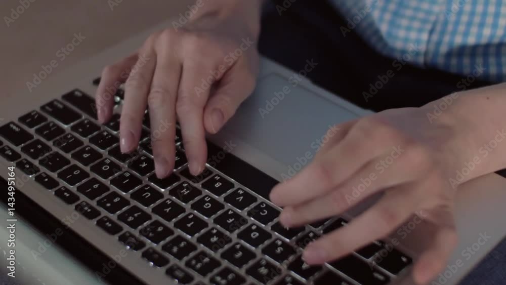Enthralled woman prints text use a laptop, located on her lap, sitting on a comfortable soft couch in the living room, tilt up Enthralled woman prints text use a laptop, located on her lap, sitting on a comfortable soft couch in the living room, tilt up