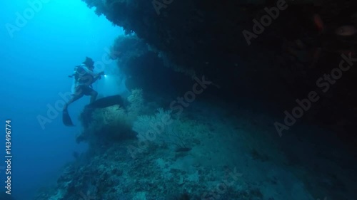Wallpaper Mural Male scuba diver looks into the cave lighting his lantern, Indian Ocean, Maldives
 Torontodigital.ca