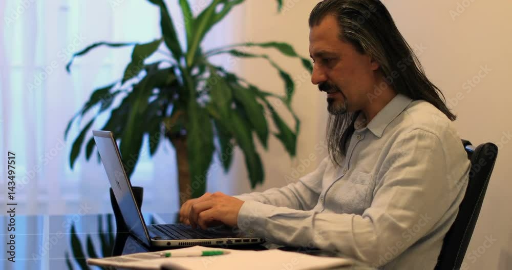 middle age attractive handsome man using laptop at office middle age attractive handsome man using laptop at office