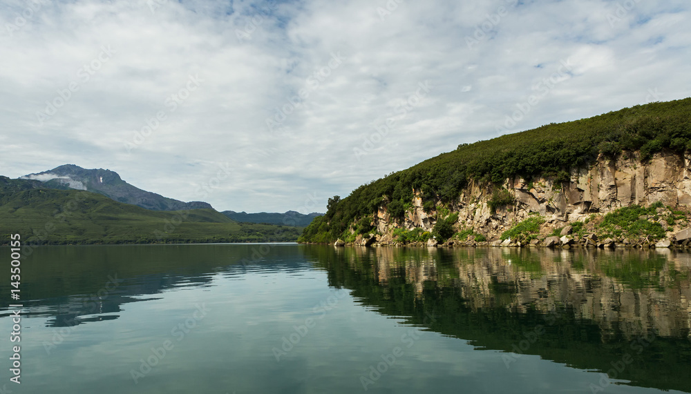 Beautiful coast of Kurile Lake is reflected in the water. Beautiful coast of Kurile Lake is reflected in the water.