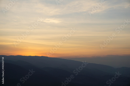 Bight and colorful high mountain landscape in haze.