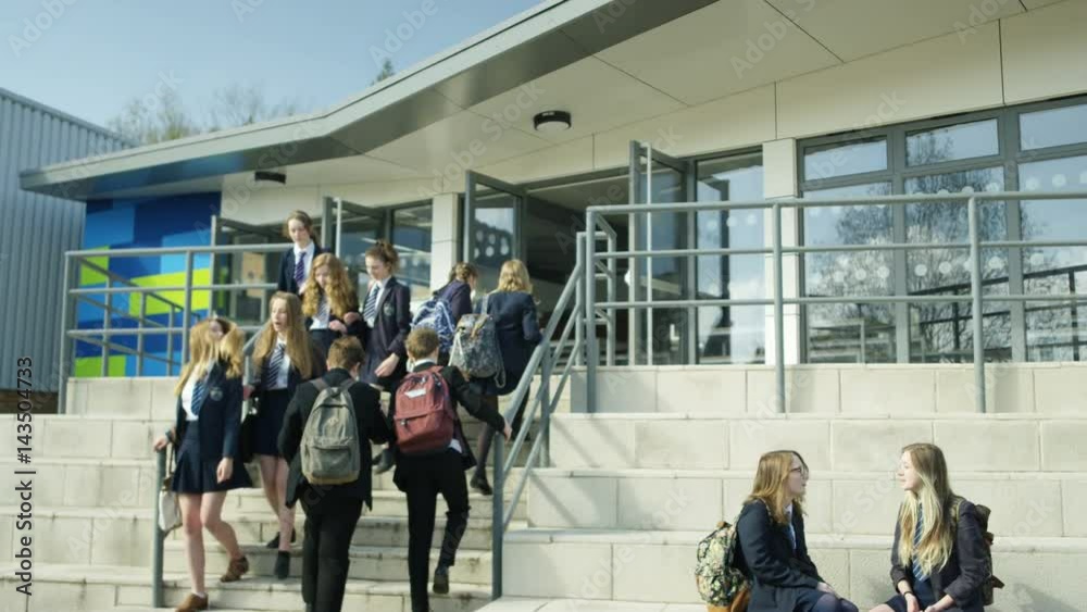  Young children walking into school building at the beginning of the day