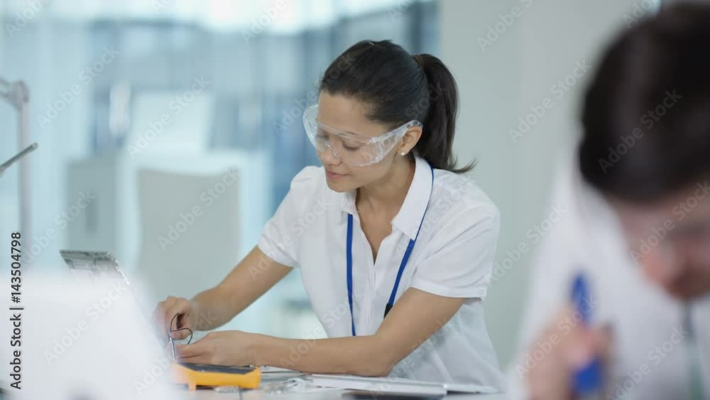  Portrait smiling electronics engineer working in the lab