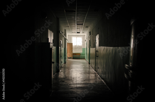 Sinister dark corridor and day lights in the window in the end. Light at the end of the way concept. © Dmitriy