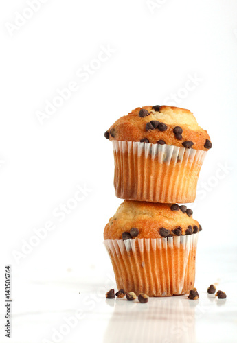 Chocolate chip muffins stacked on top of each other on a white isolated background 