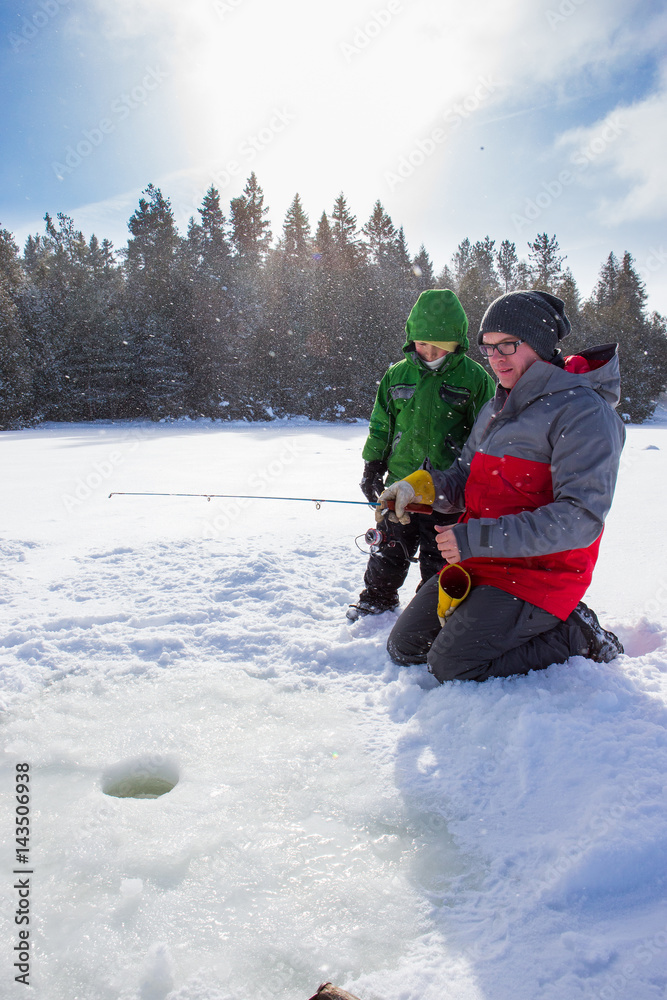 Mixed race family ice fishing
