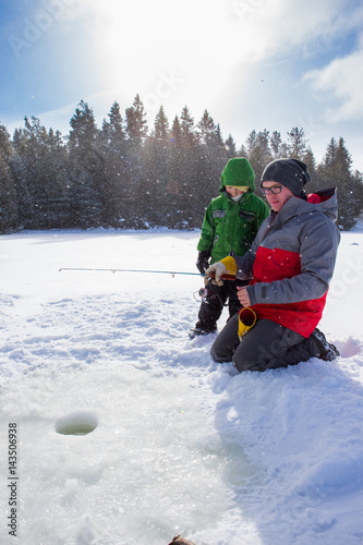 Obraz na płótnie Mixed race family ice fishing w salonie