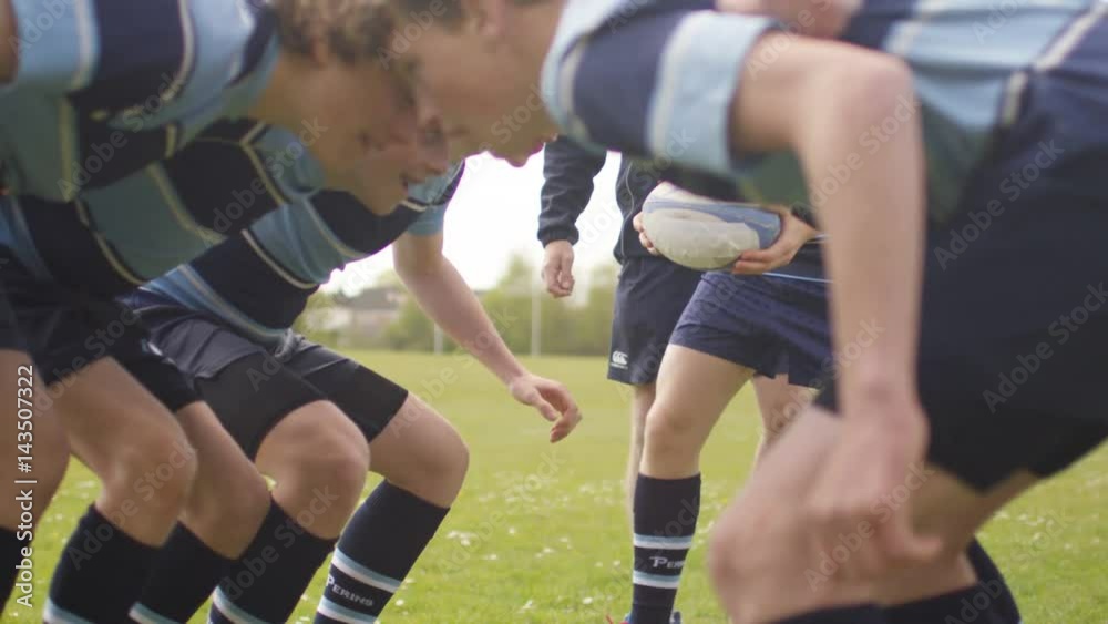 Young team players in a scrum at rugby match Young team players in a scrum at rugby match