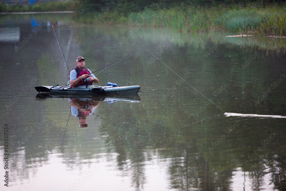 Middle aged man kayak fishing