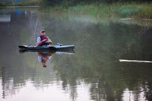 Obraz na płótnie Middle aged man kayak fishing w salonie