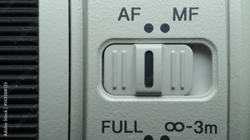 Camera lens manual MF and auto AF focus switch close up. Dolly slider shot 4K ProRes HQ codec Camera lens manual MF and auto AF focus switch close up. Dolly slider shot 4K ProRes HQ codec