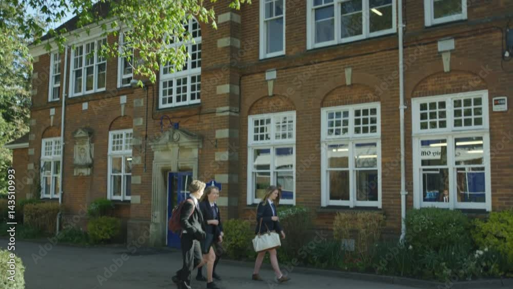 Young children entering school building at the beginning of the day