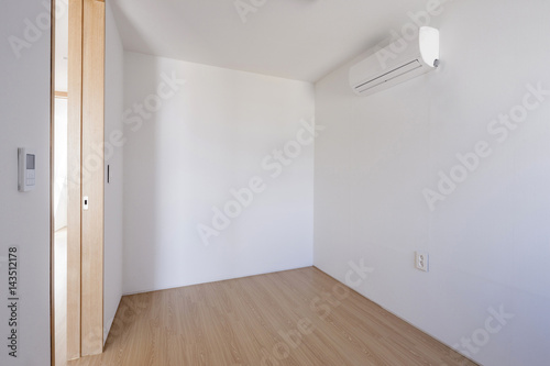 empty white room with wood door.