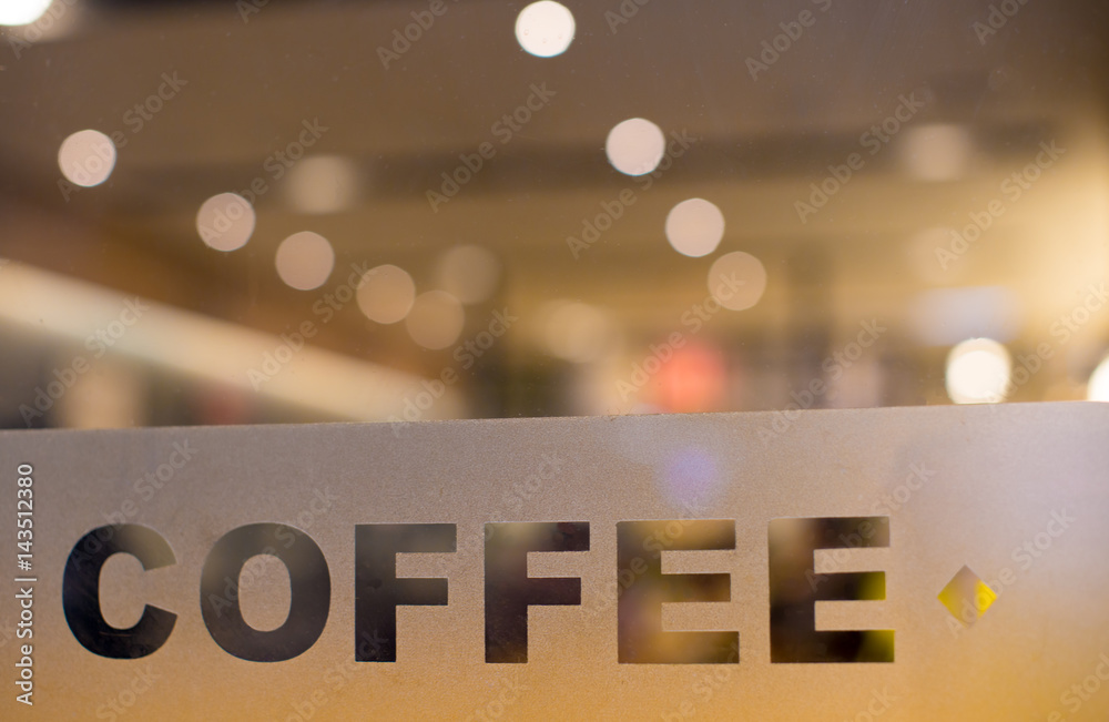 Coffee etched on Glass Window. Shop, Cafe, Restaurant Tables and Chairs in Background