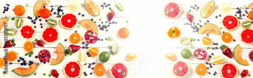 Mixed fruits on a white wooden table.