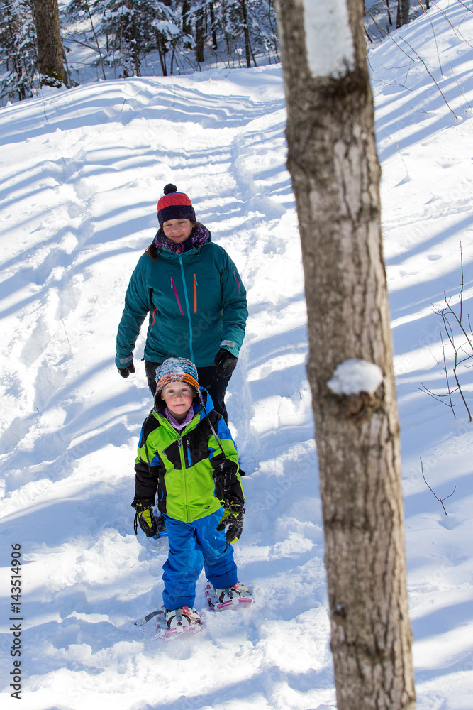 Mother and sun snowshoeing in Ontario, Canada