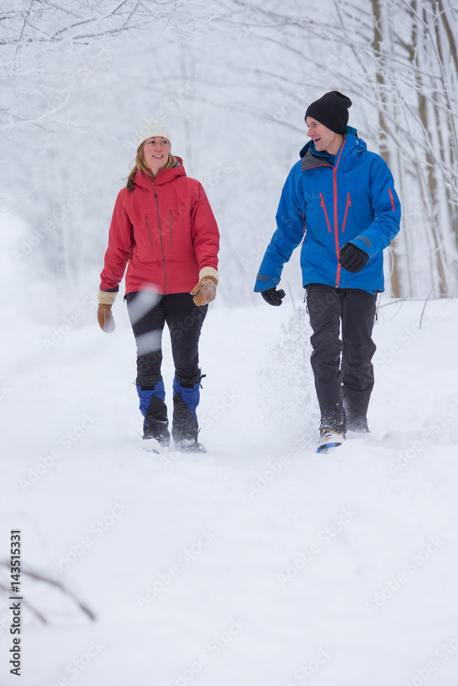 Couple snow shoes in the forest in the winter