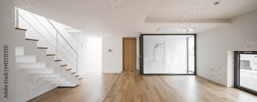 white empty living room with stair, window, pendant lighting, stair at the day.