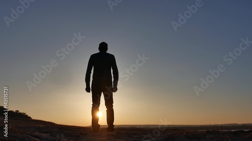 freedom. Man stands on a cliff sunset silhouette hand in lifestyle the sides © maxximmm