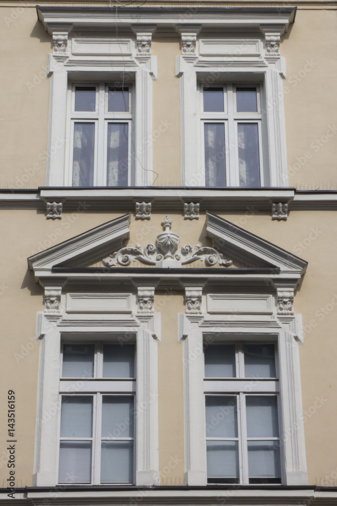 Four vintage design windows on the facade of the old house